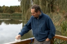 Photo of Claude Roy, activity leader at the Tree House, in front of a pond